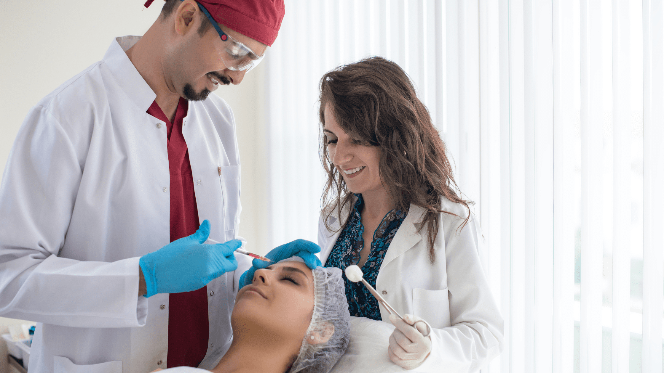 Two plastic surgery residents and their patient.