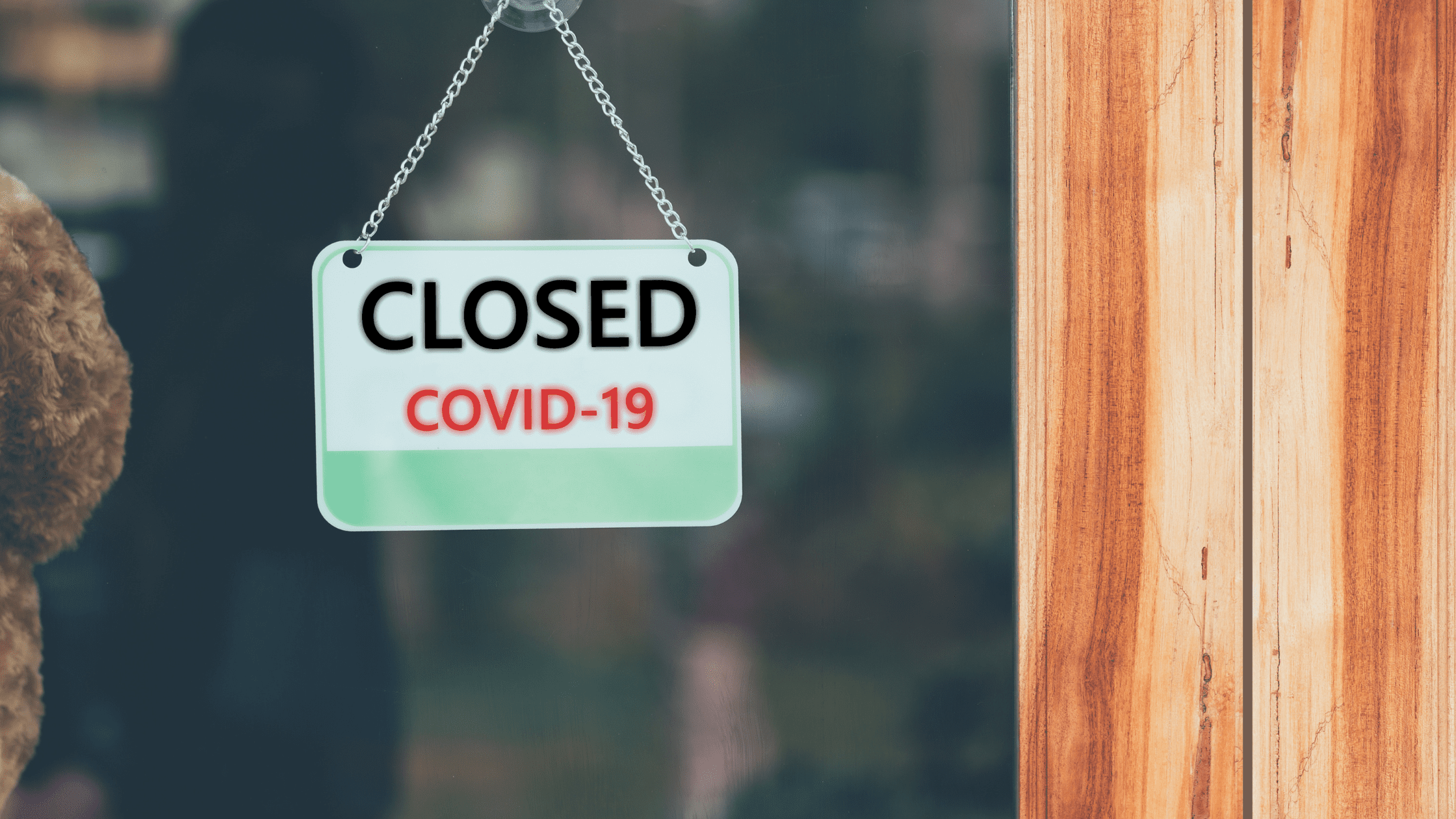 A sign at the window of a Prometric testing center saying "Closed COVID-19".