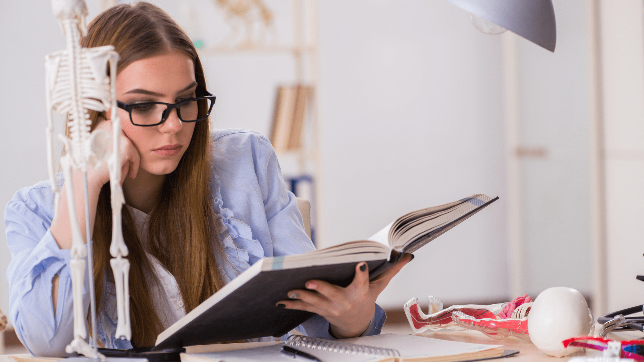 A medical school student using a First Aid study book to study for the USMLE Step 1.