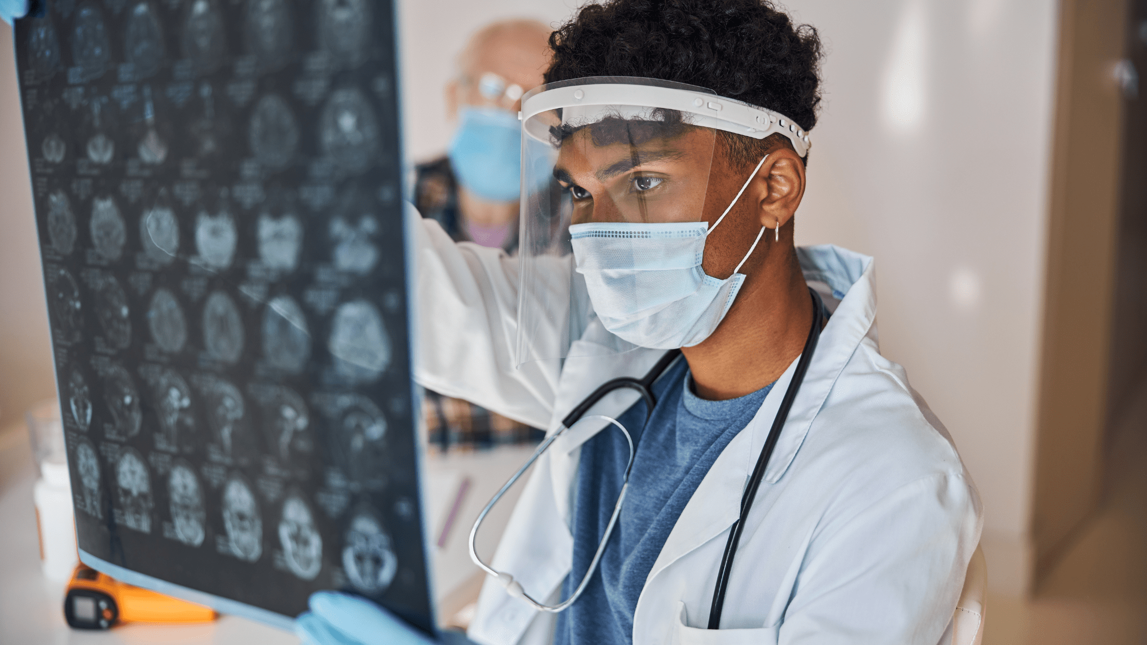 A young Neurologist looking at brain MRI imaging.