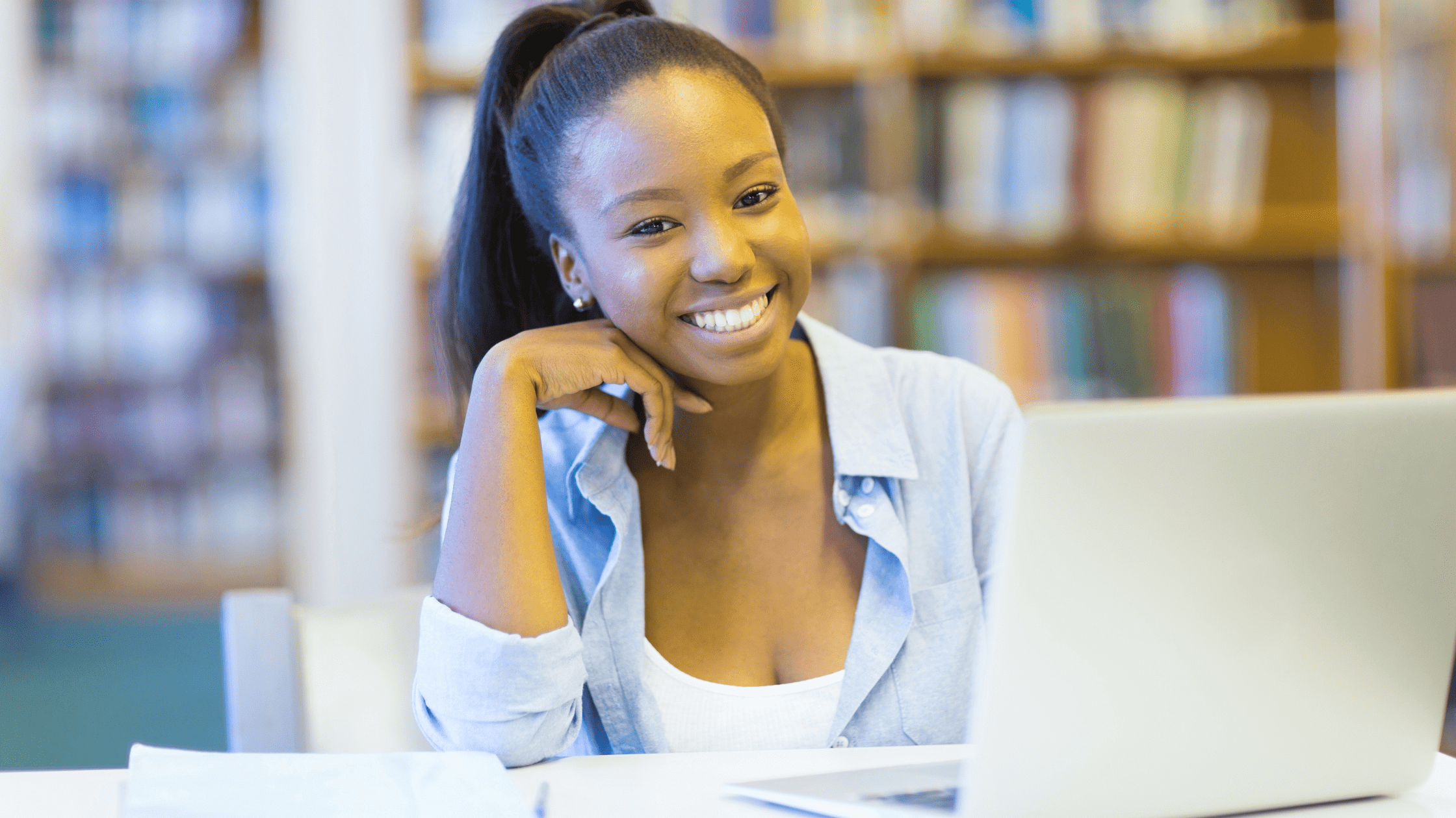 Medical school student studying for the USMLE in a library in front of a laptop, making the most of her UWorld subscription.