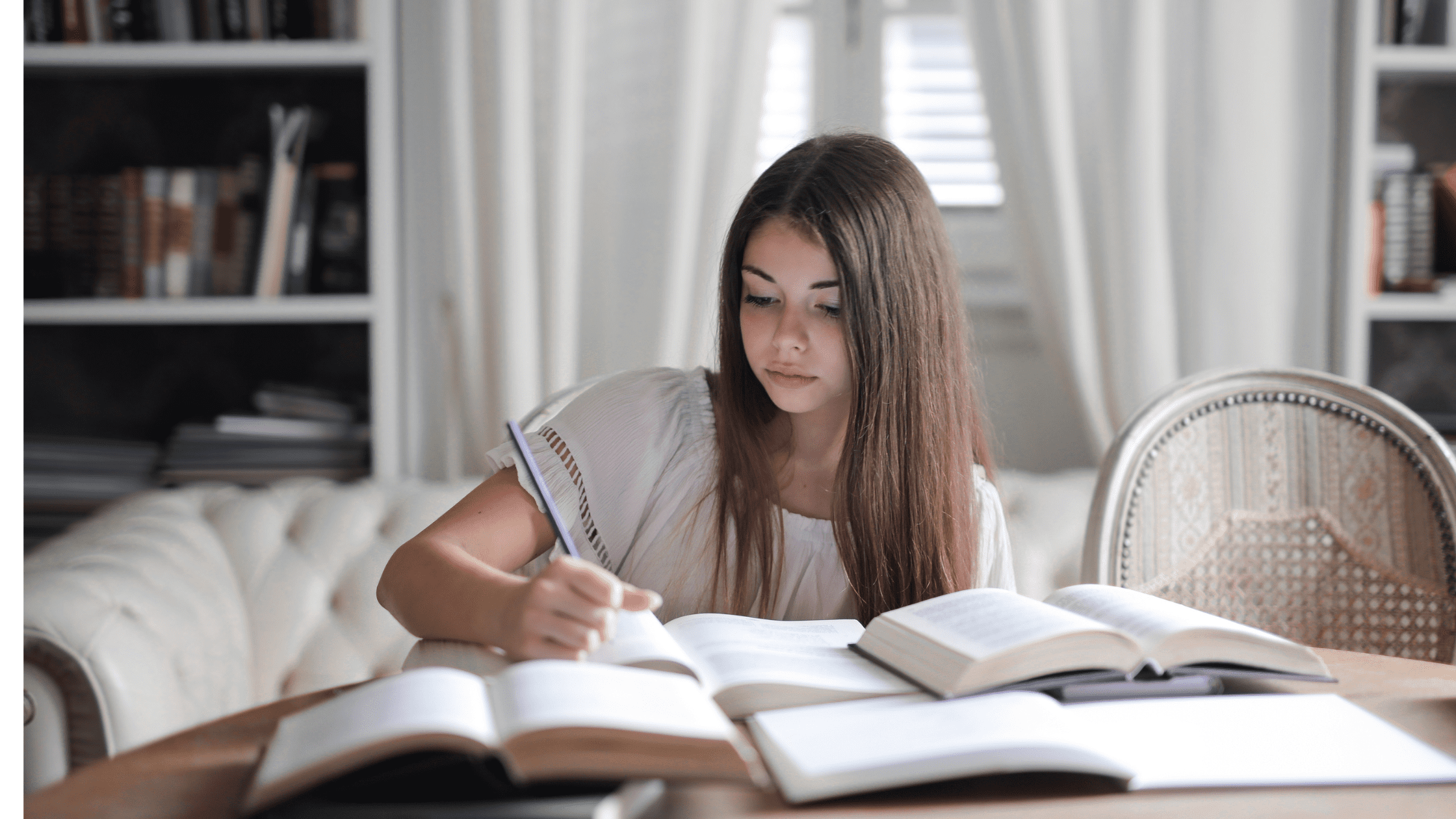 Student with a number of open books studying for USMLE Step 2 CK and Shelf Exams