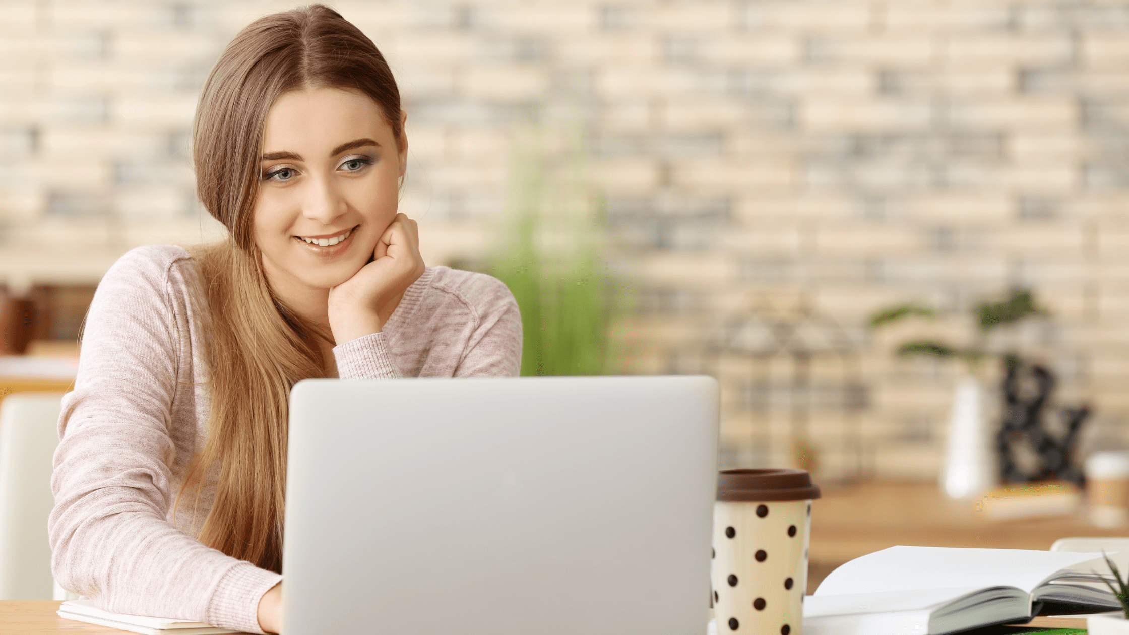 A pre-med student studying for the MCAT at home in front of her laptop.