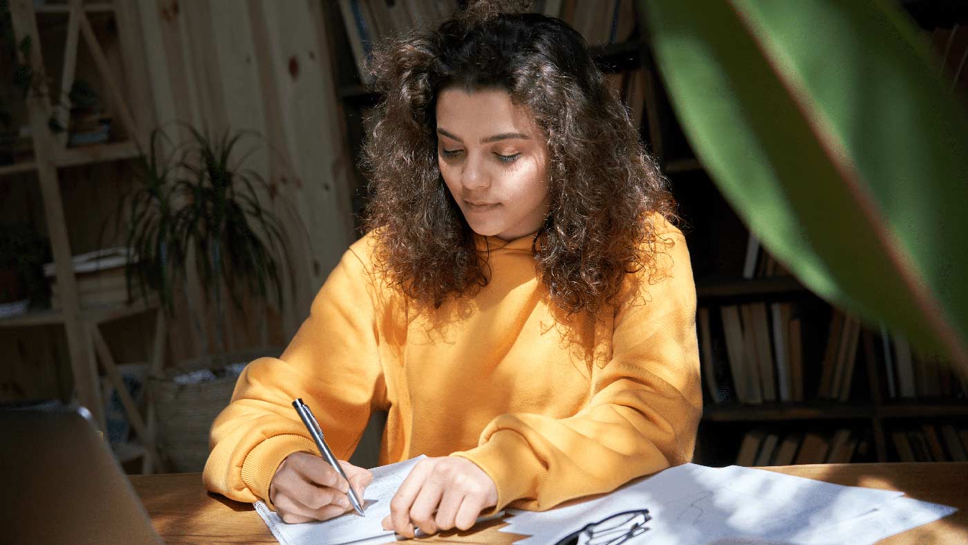 A med school student taking an NBME practice exam in preparation for Step 1 in a library.