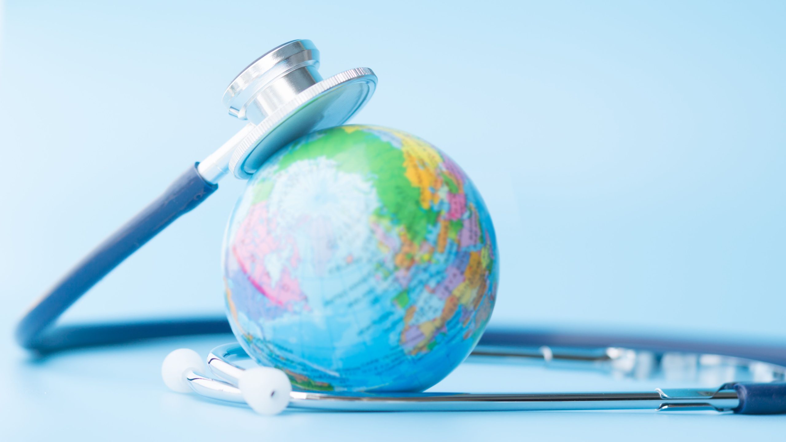 A stethoscope wrapped around a globe.