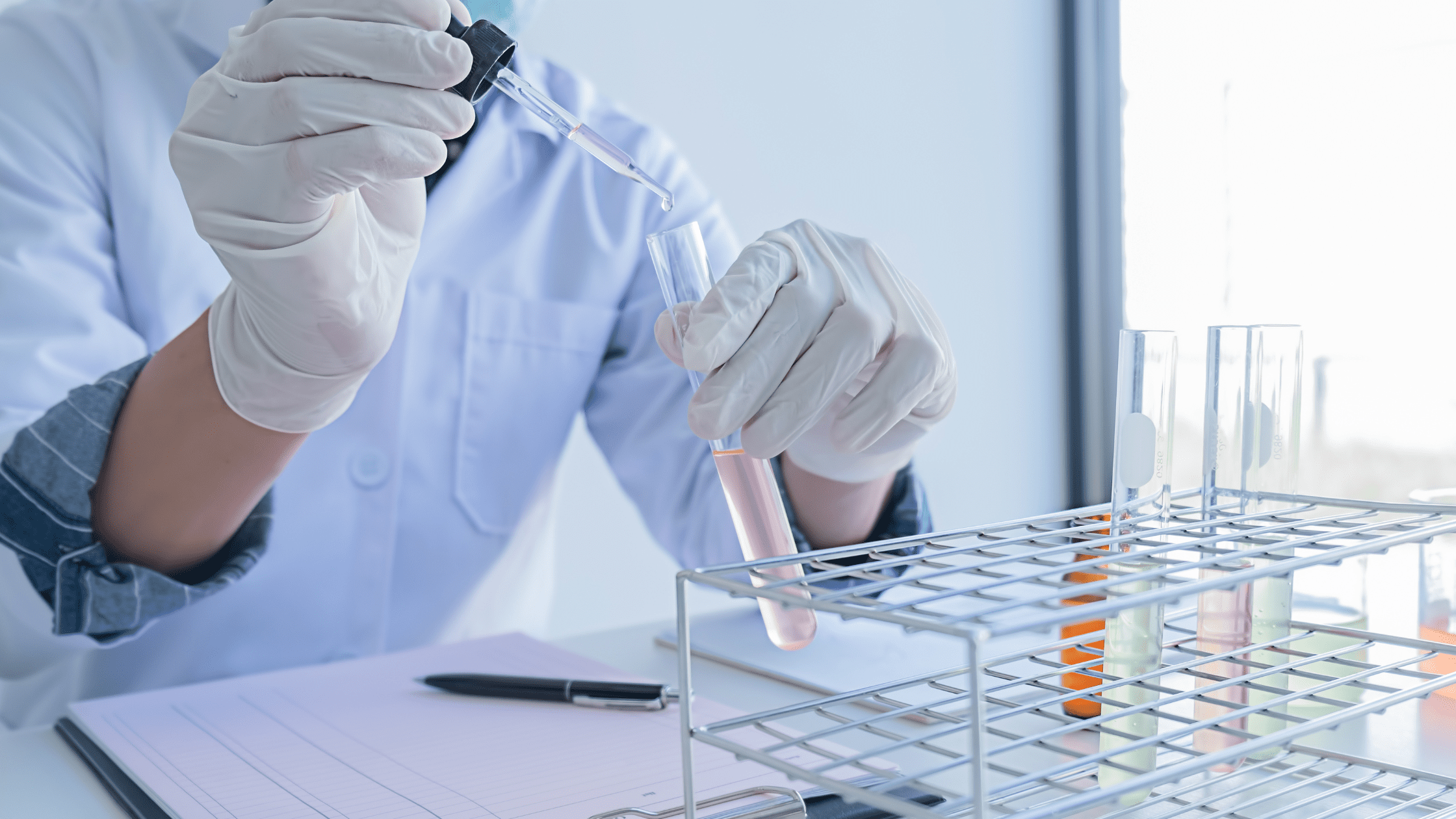 A medical student in a lab testing and focusing on pre-med research position.